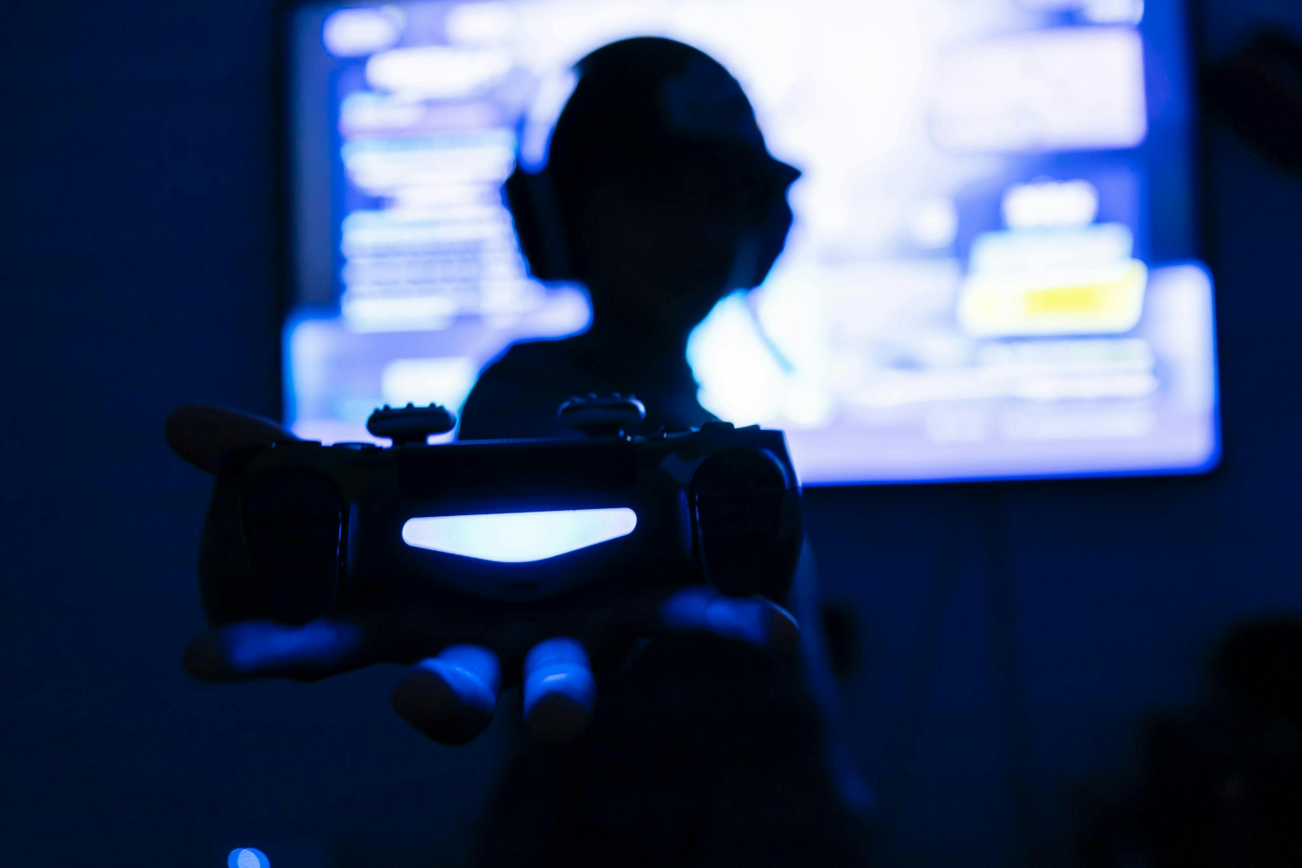 Silhouette of a man playing video games